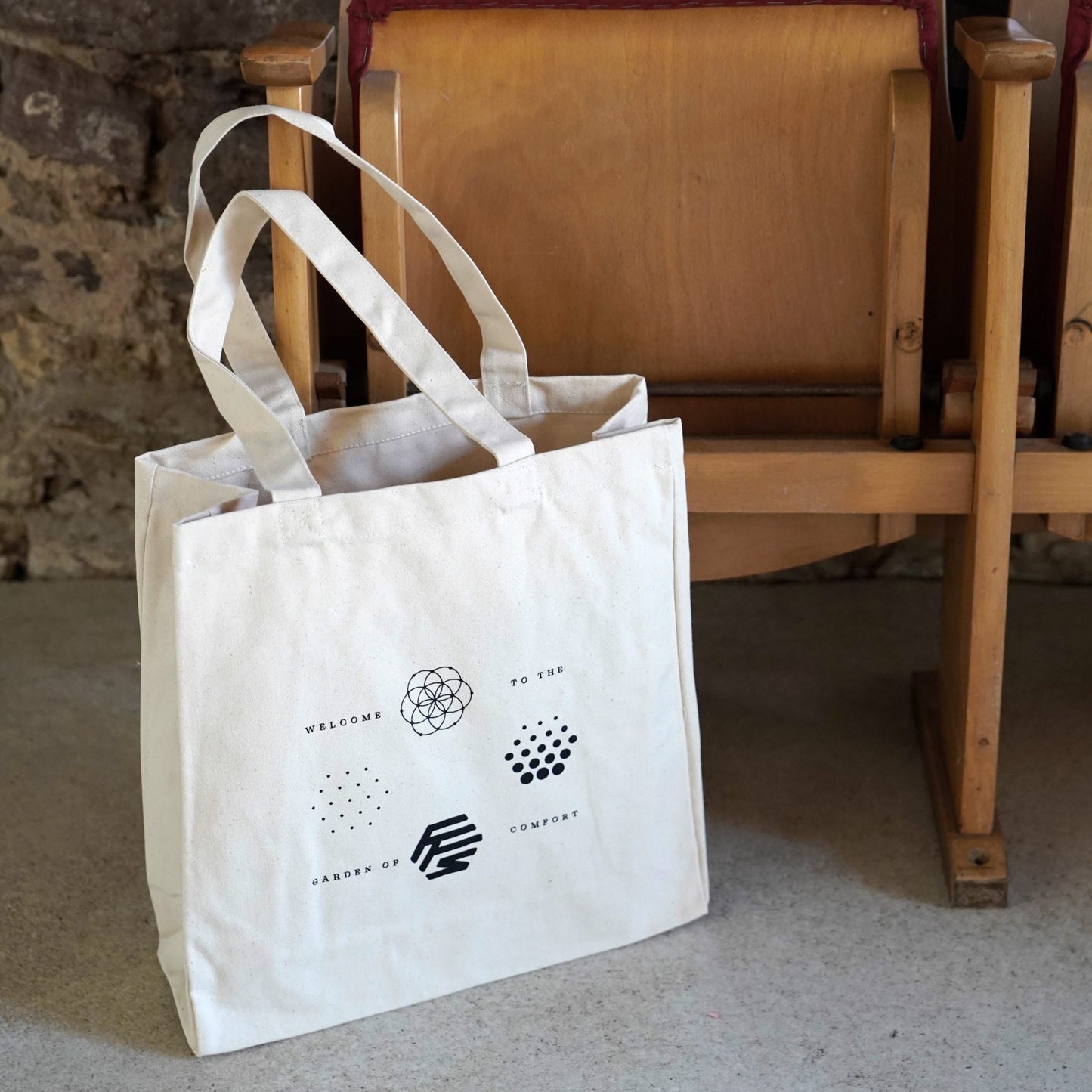 Flowers for Society OG logos jute bag nature side view standing in front of wooden bench