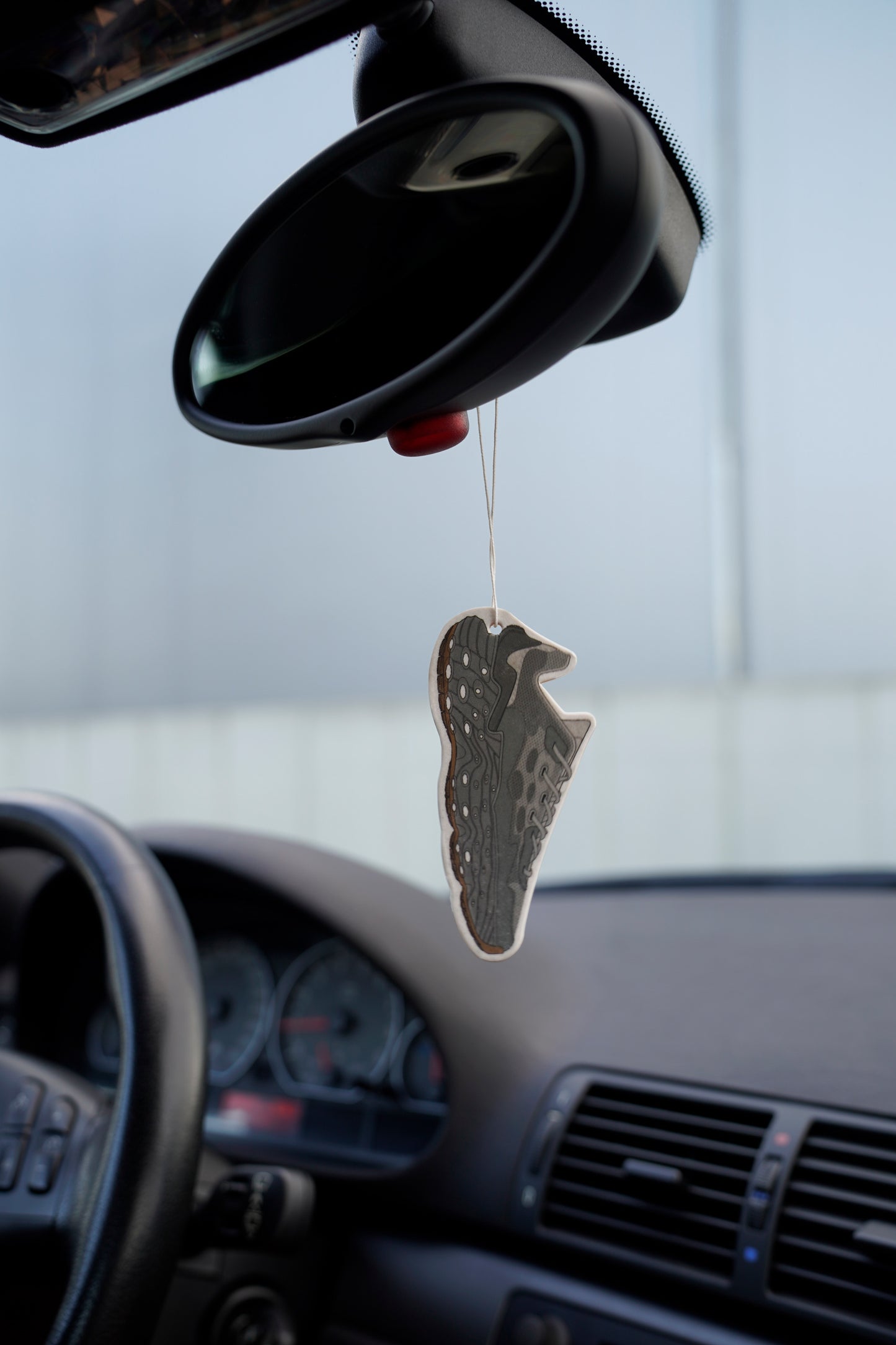 Flowers for Society Seed.One car fragrance grey front view hanging on rear-view mirror in car