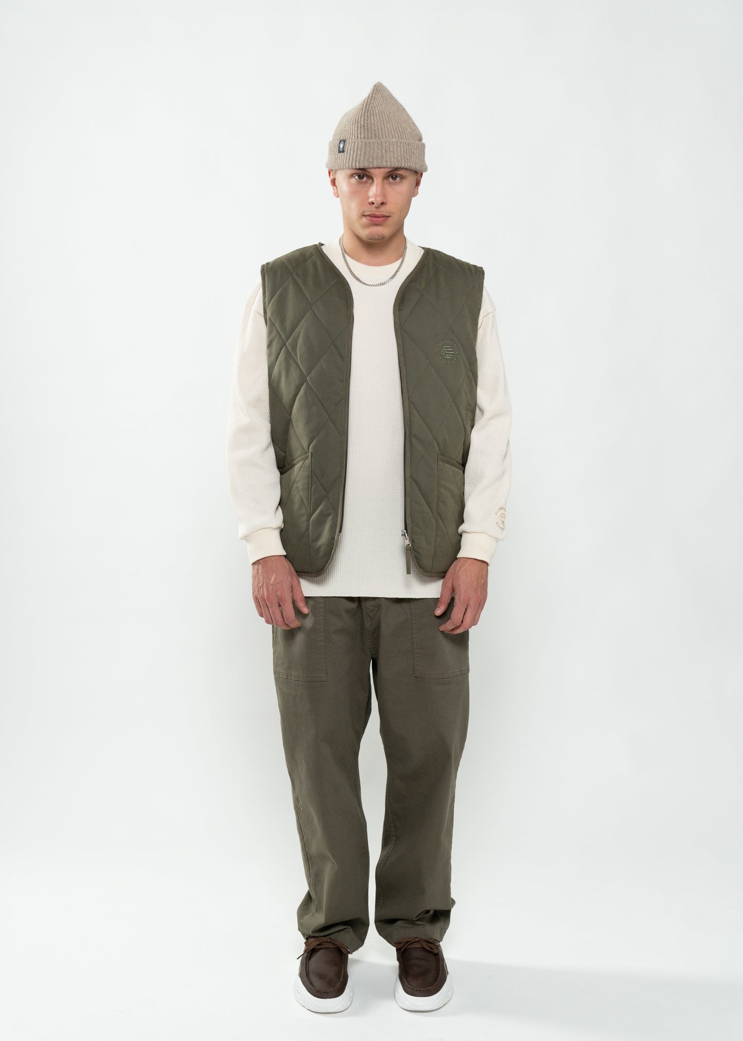 Flowers for Society reversible vest olive frontview worn by model Ben standing
