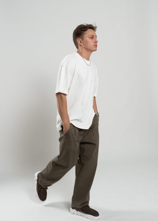 Flowers for Society chino pant olive sideview worn by model Ben walking