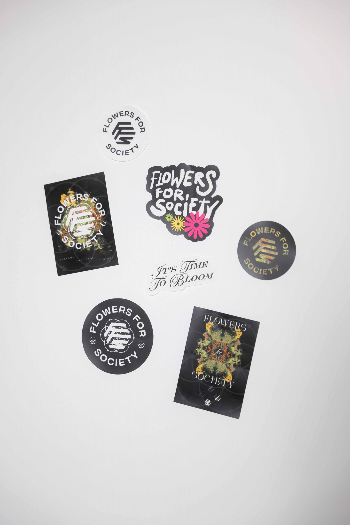 Flowers for Society logo sticker pack multicolor topview laying on white background