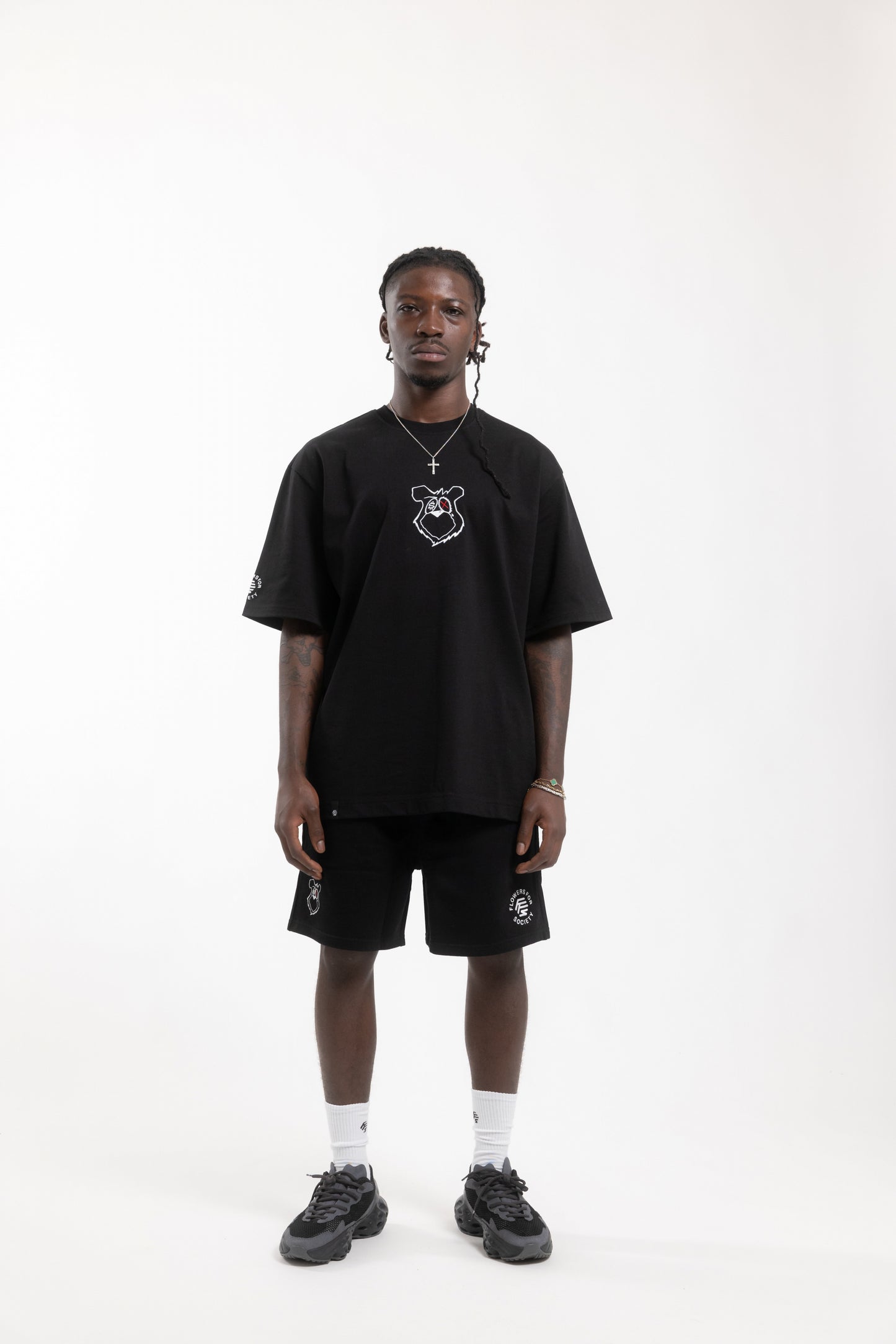Flowers for Society King Saladeen shorts collaboration King Saladeen black frontview worn by model standing