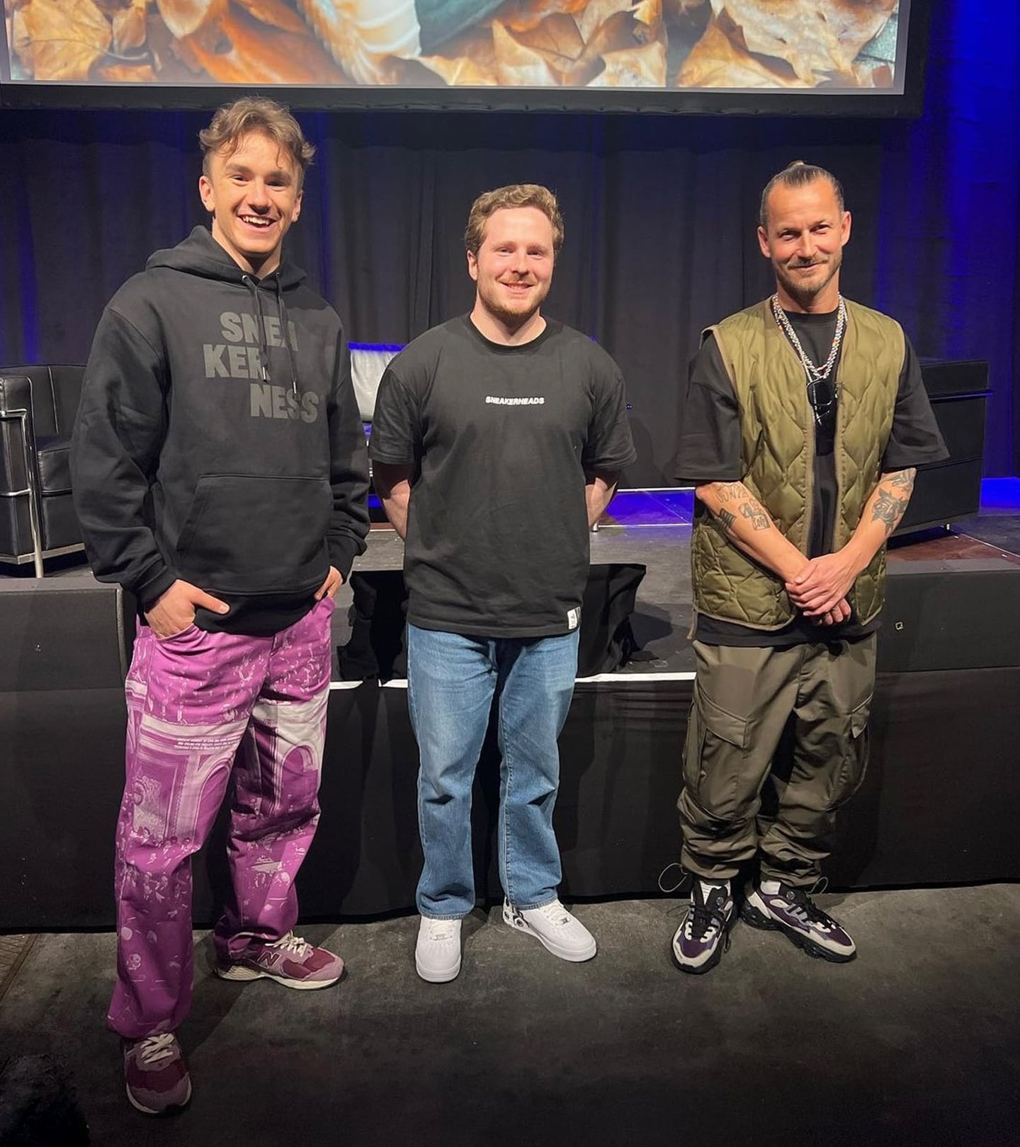 Three guys standing in front of a stage at the Sneakerness Zuerich, on the left is Tamás Dablty and on the right is Till Jagla