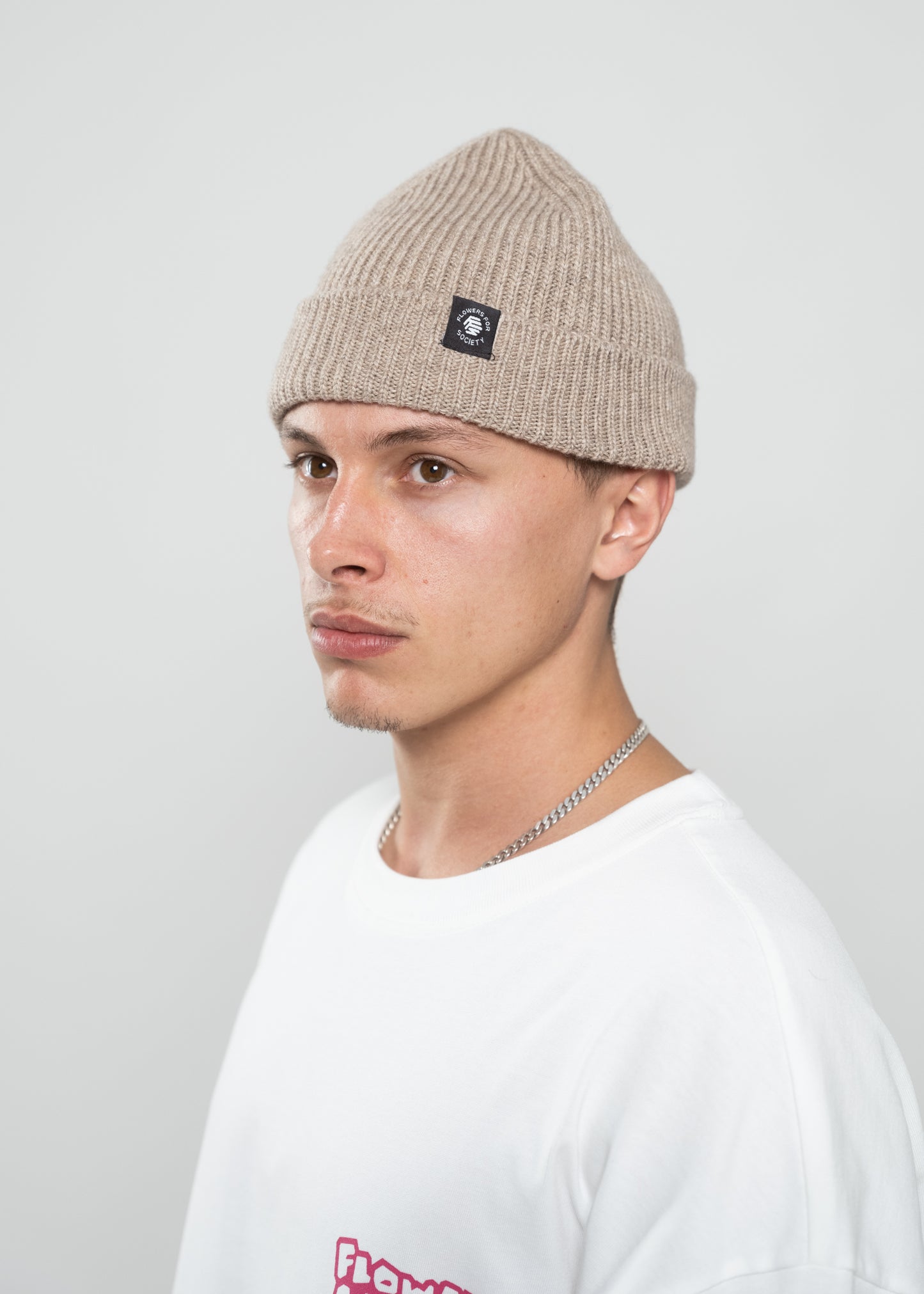 Flowers for Society beanie creme sideview worn by model Ben