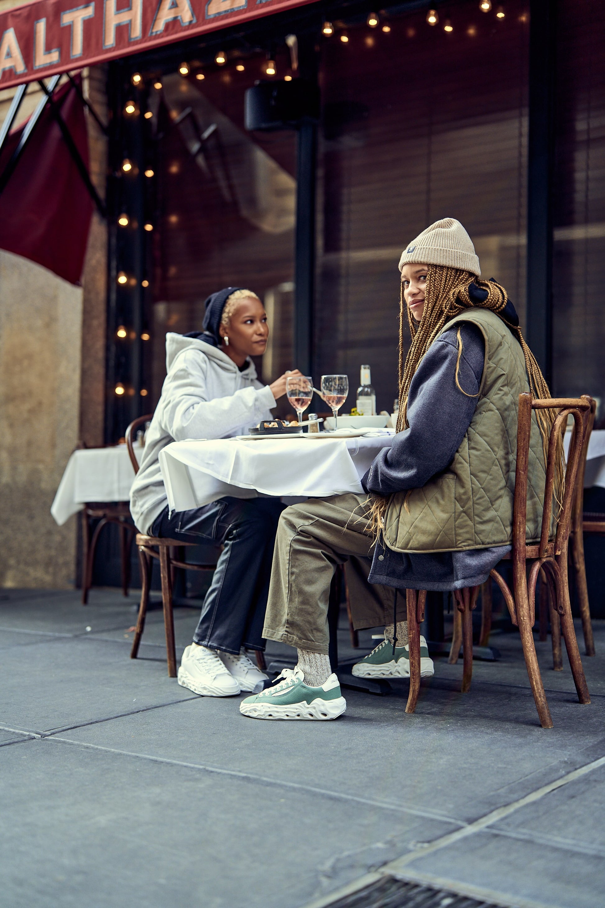 Flowers For Society Sneaker Radicle Topless green lateral worn by model sitting at the restaurant table