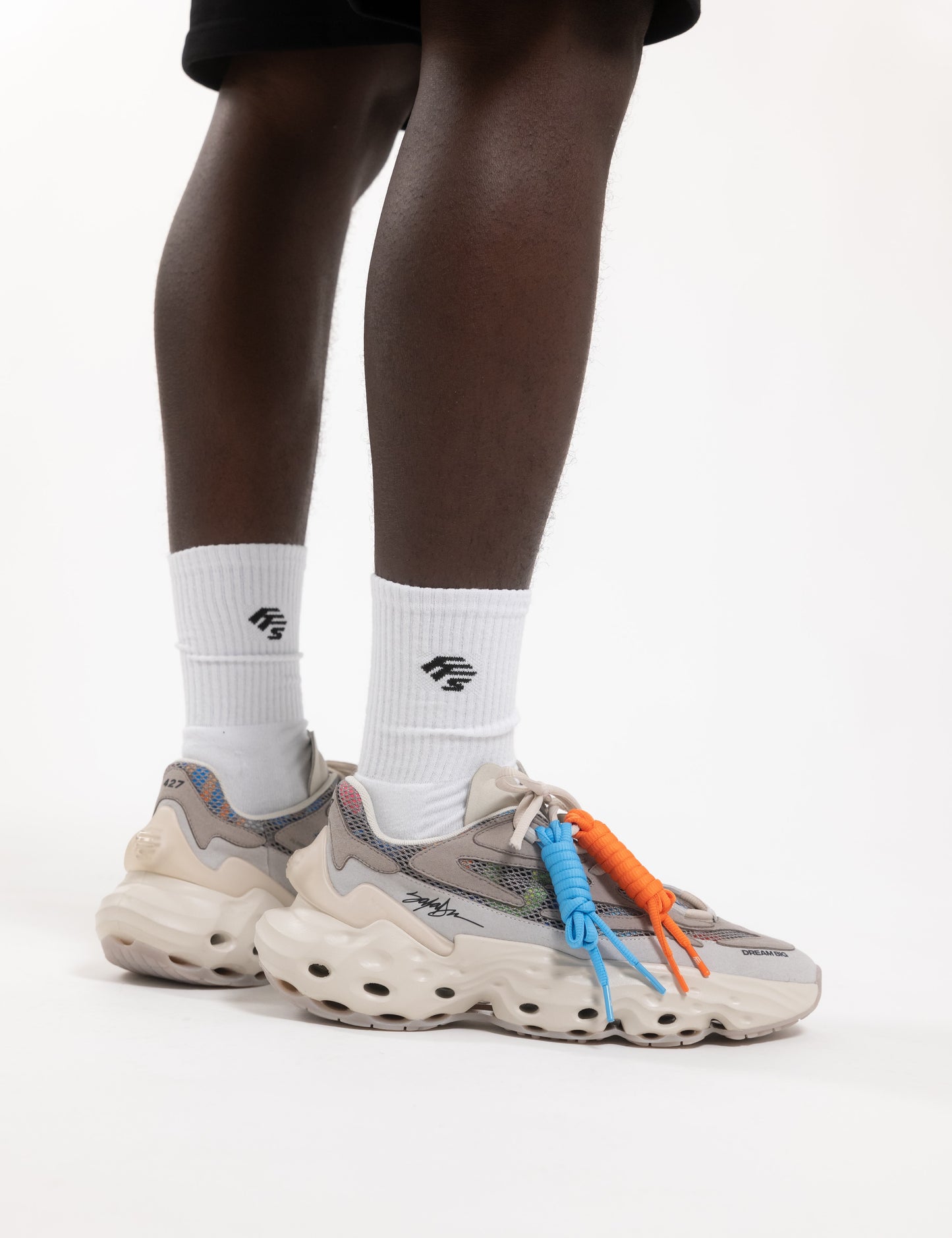 Flowers for Society Sneaker Seed.One King Saladeen collaboration lateral worn by model standing straight