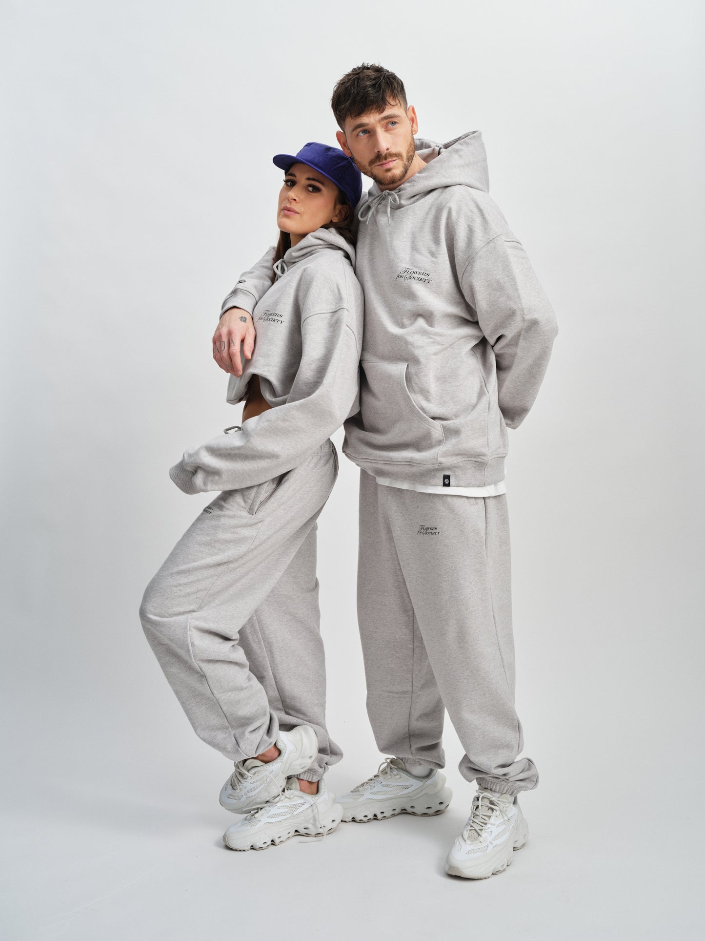 Flowers for Society bouquet pant grey sideview worn by models Imke and Angelo standing