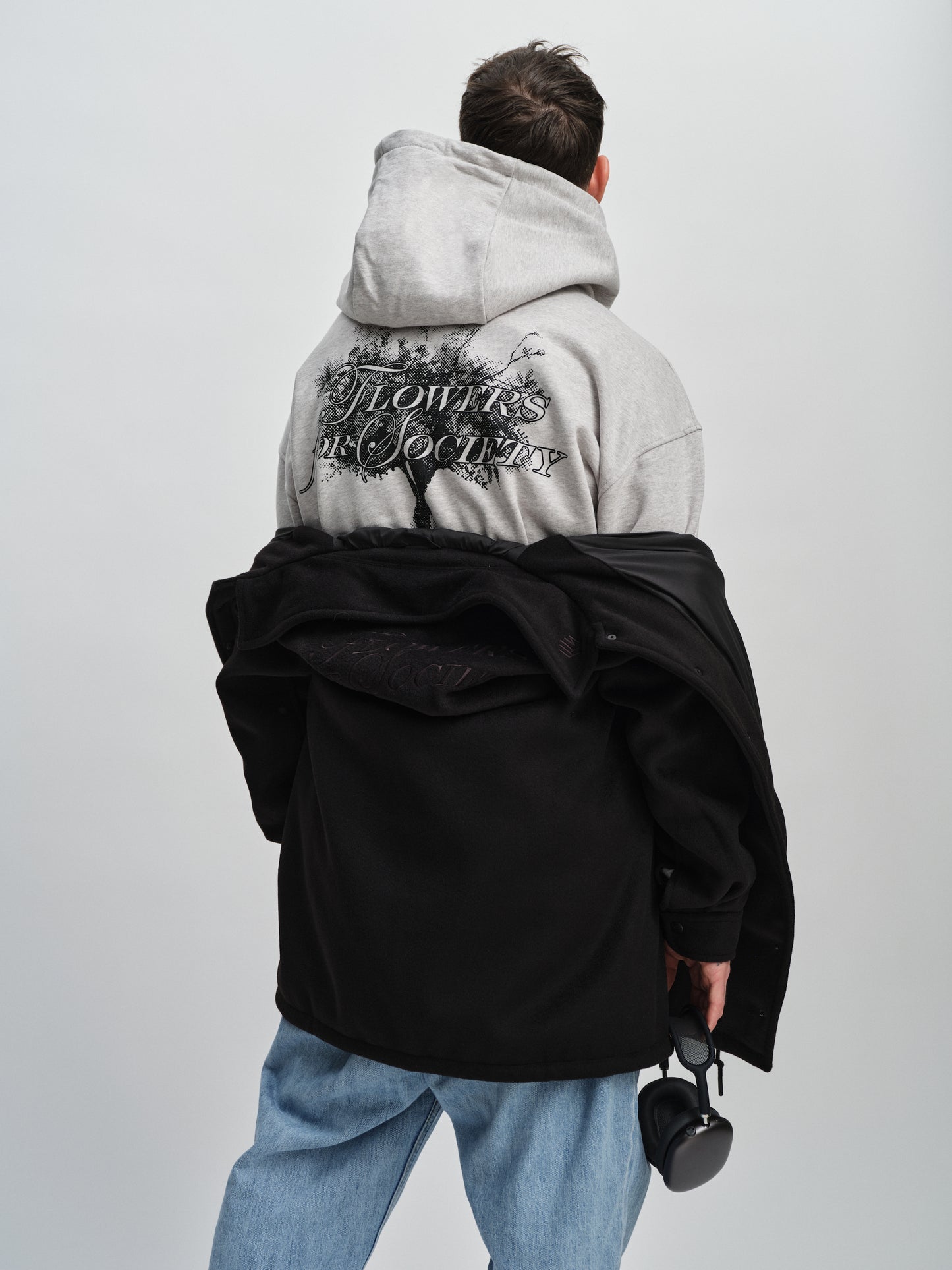 Flowers for Society bouquet hoodie grey side back view worn by model Angelo standing