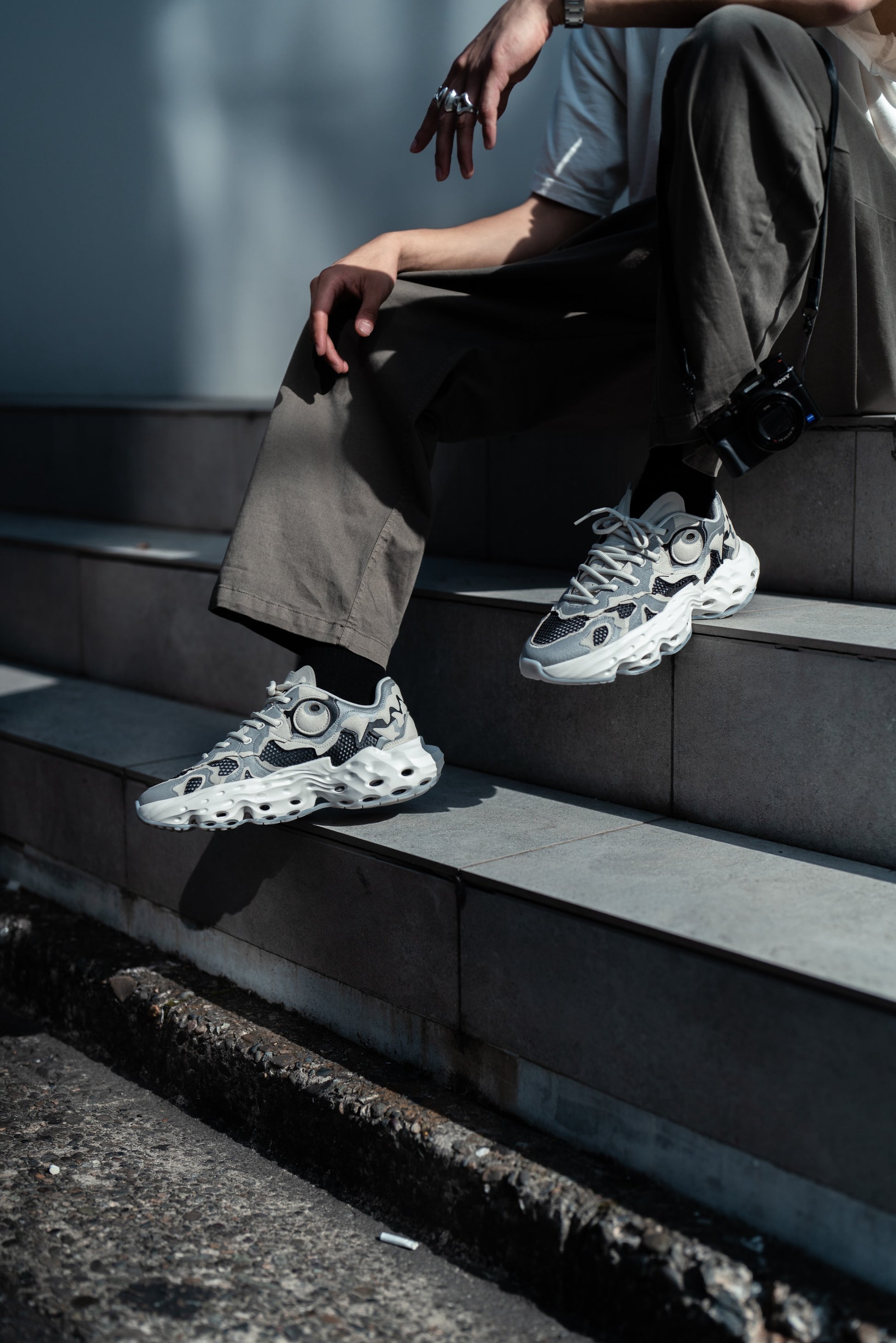 Flowers for Society Sneaker Seed.One Bone Dragon collaboration Oremob sideview worn by model sitting on stairs