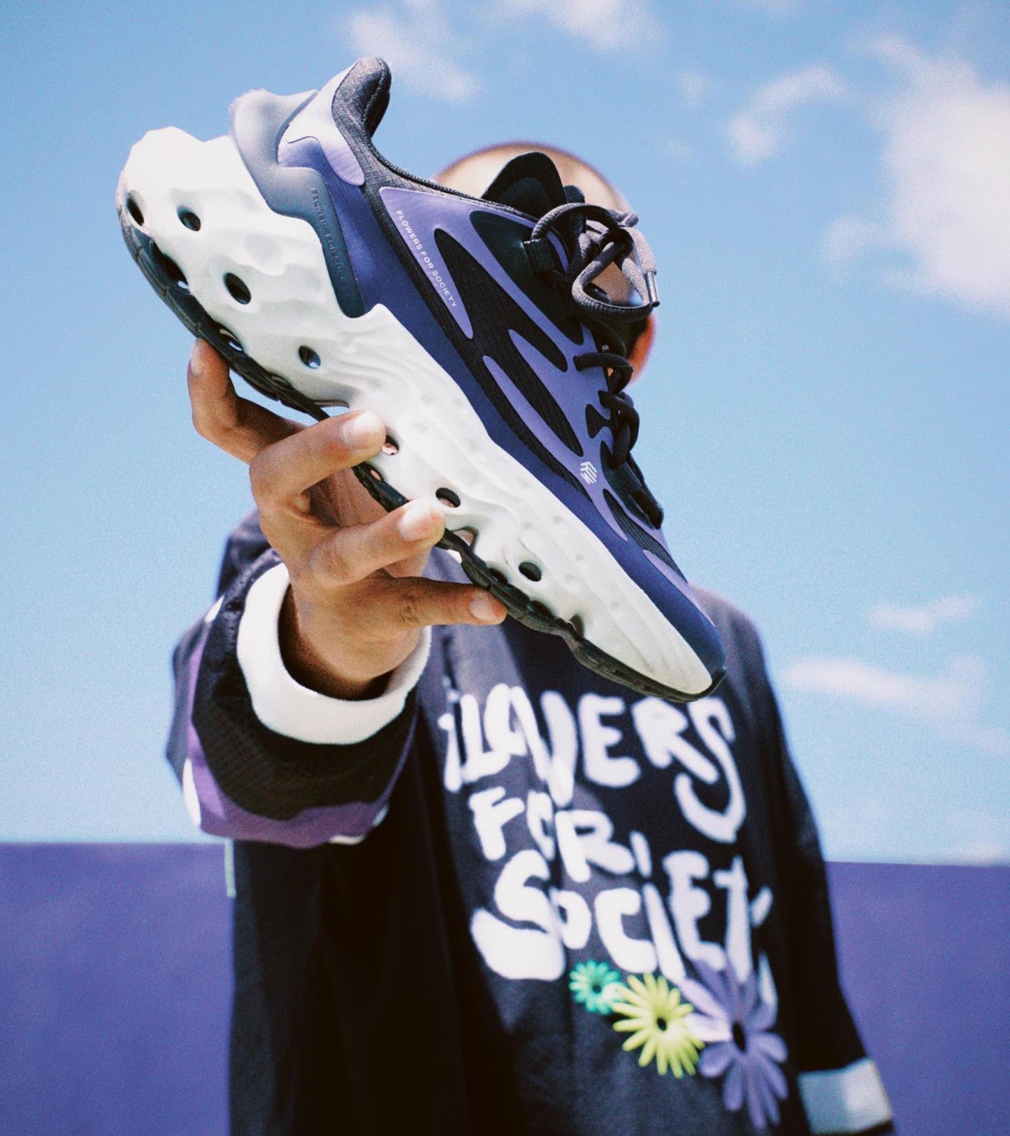 Flowers for Society Sneaker Seed.One Orient purple black lateral held by model Ben